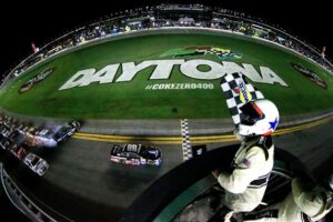 Dale Earnhardt Jr. scores the victory at Daytona as hell breaks loose behind him. Photo: Chris Trotman/NASCAR via Getty Images