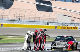 NASCAR Officials pull the pit crew of Kurt Busch away from the car as the red flag is displayed. Photo by Rachel Myers for Speedway Media.