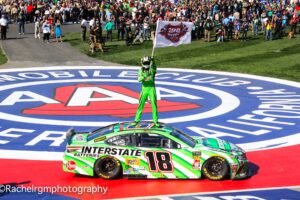 Kyle Busch waves a "200 Wins" flag in celebration of his 200th career victory in NASCAR's premier top touring series. Photo by Rachel Schuoler of Speedway Media.
