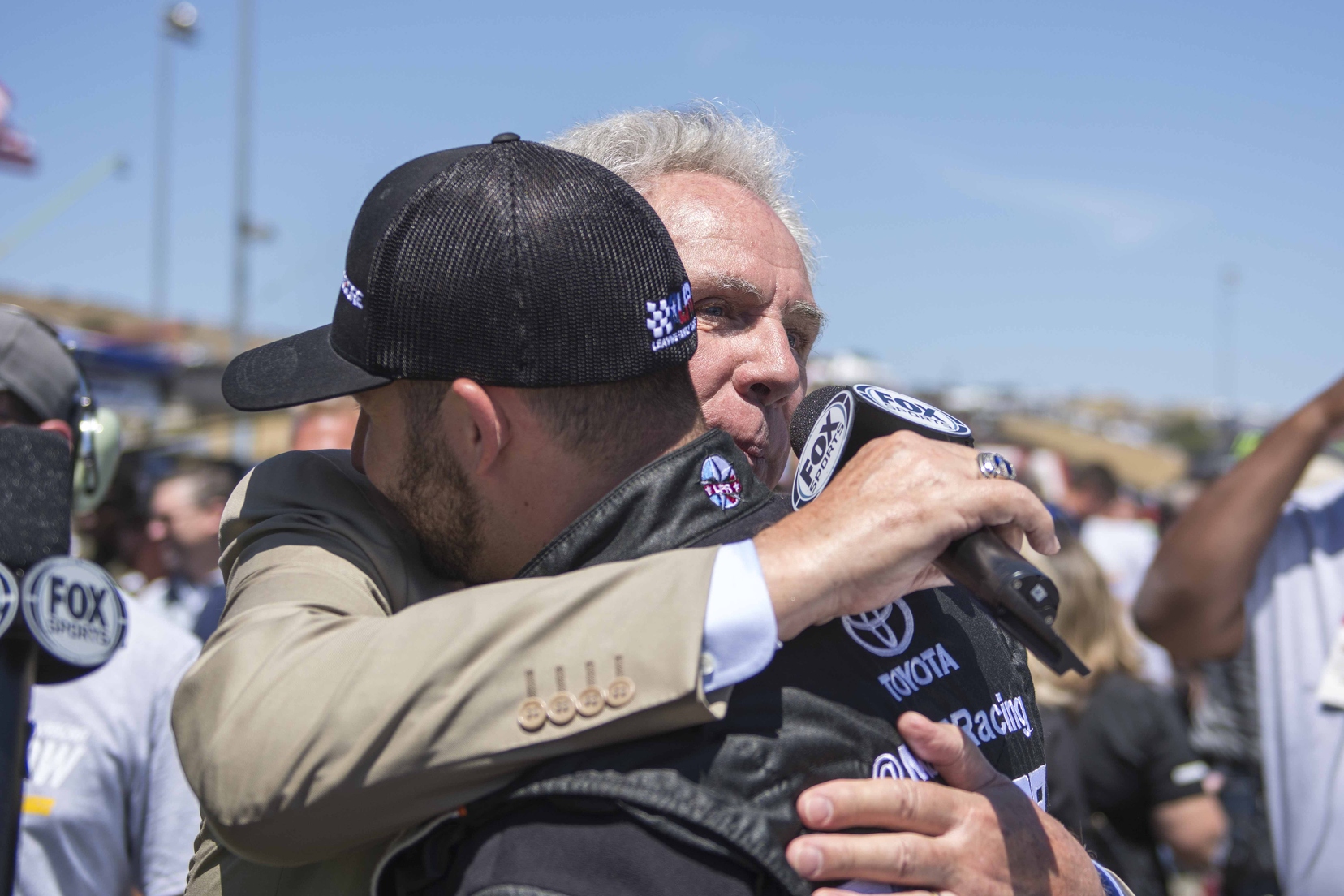 Darrell Waltrip and Matt DiBenedetto share a hug during pre-race ceremonies for Waltrip's final broadcast. Photo courtesy of Patrick Sue-Chan for Speedway Media.
