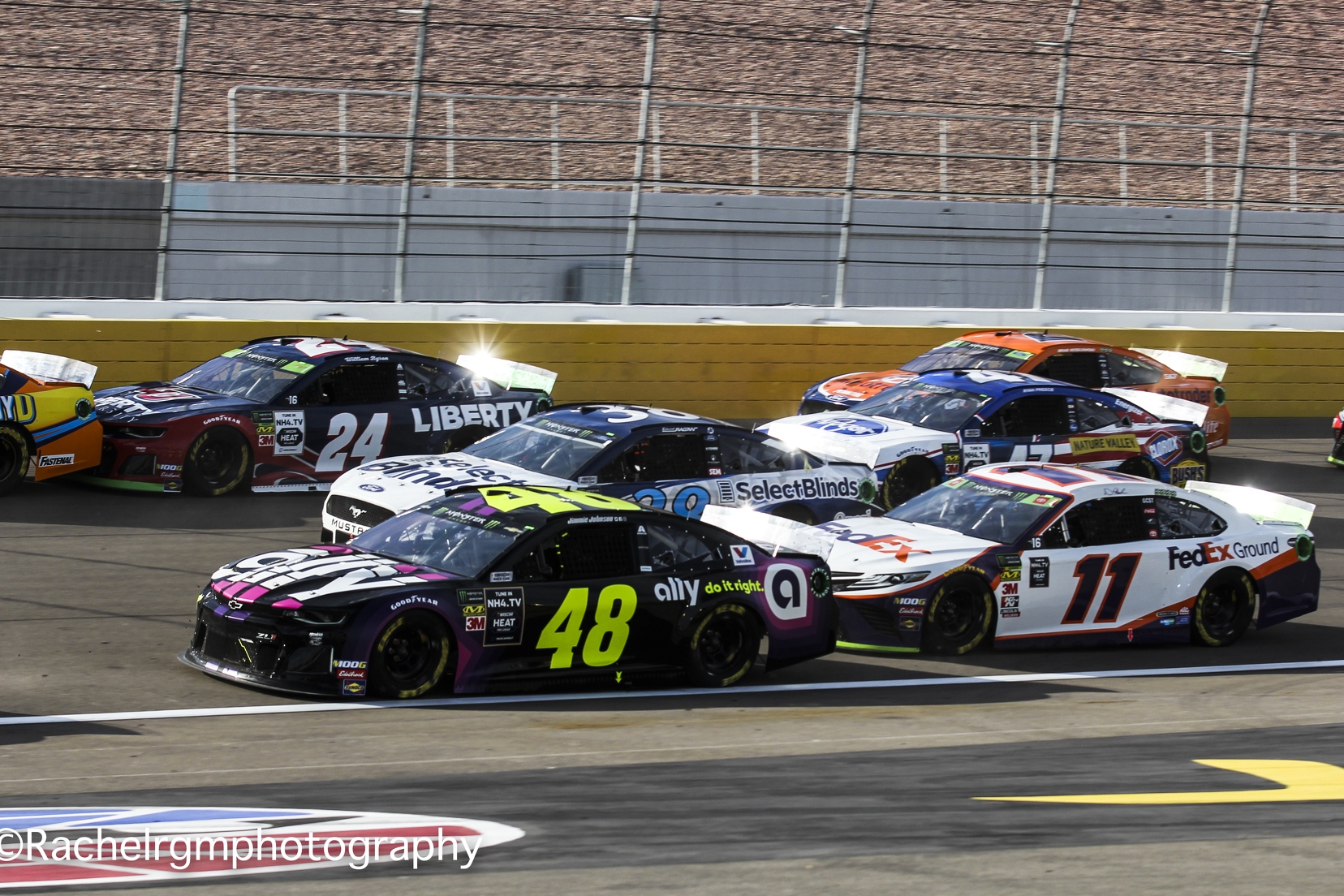 Jimmie Johnson and Denny Hamlin make it three-wide going into Turn 1 at Las Vegas Motor Speedway.